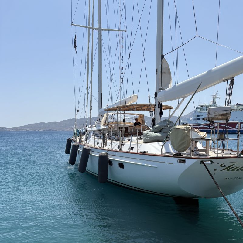 Customer photo of Hauraki inflatable fenders, covers and other products in use. White sailboat docked in clear blue water with a clear sky